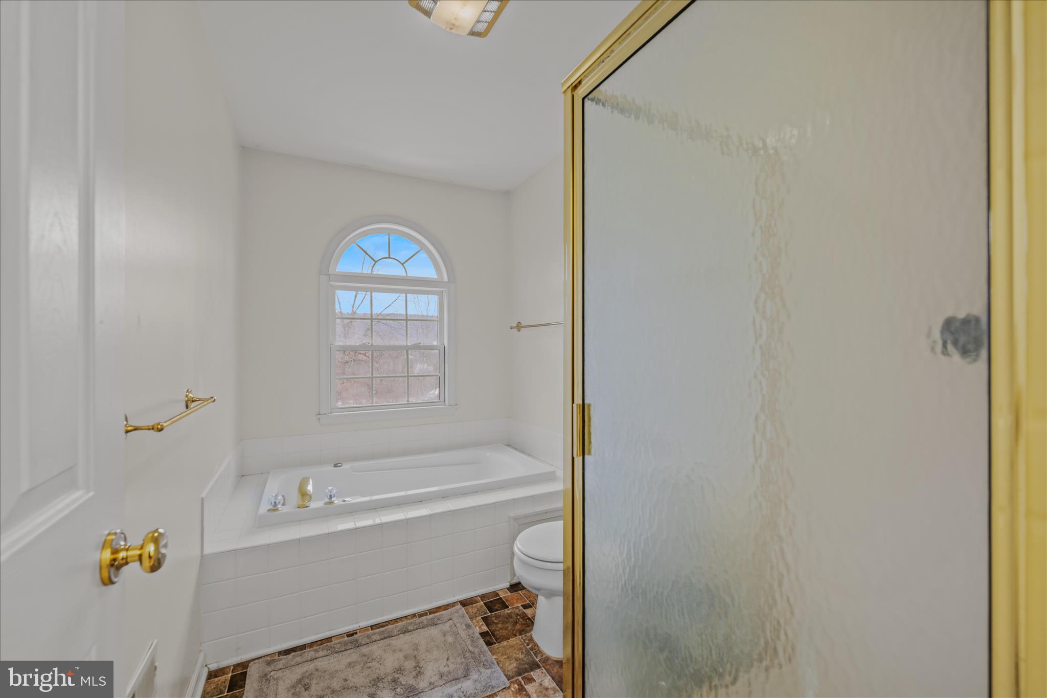 2509 Highland Ridge Road Berkeley Springs, WV 25411 - Photo 30 of 68 a bathroom with a bathtub and a shower
