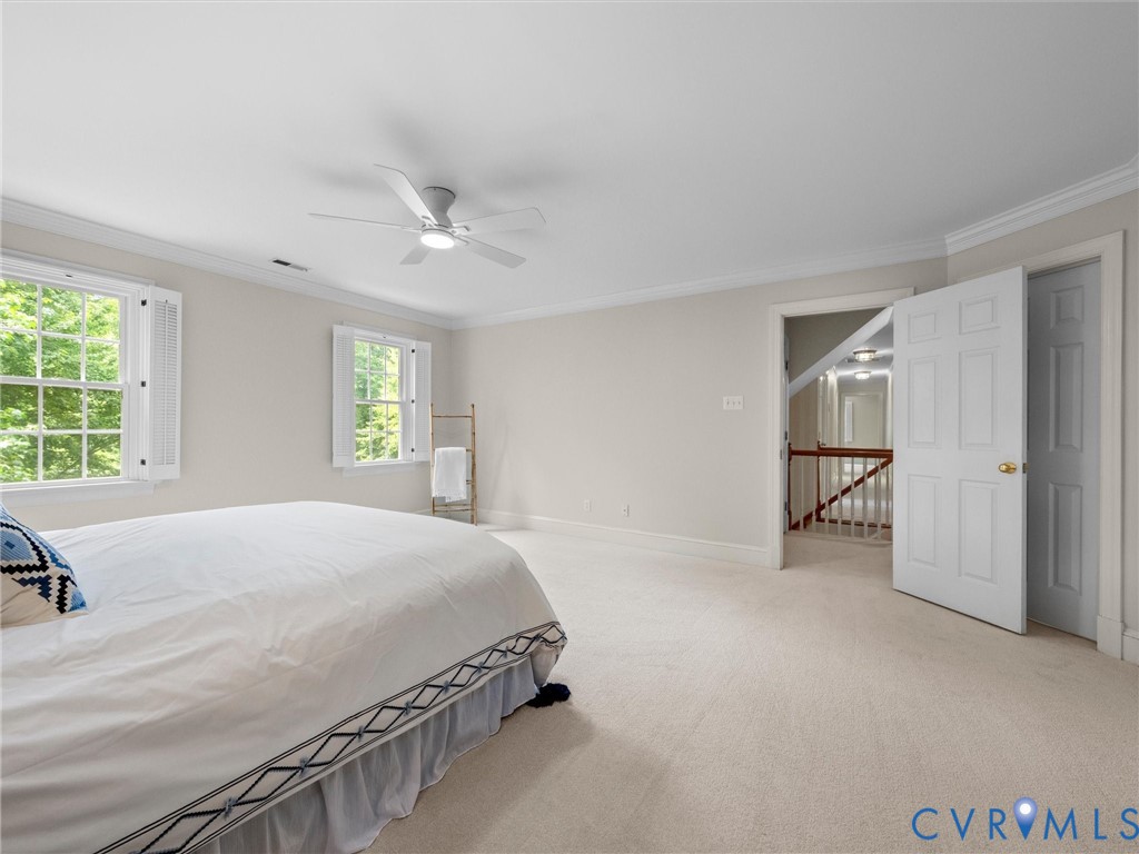2011 Gamelaw Court Midlothian, VA 23113 - Photo 41 of 77 a bedroom with a large bed and a chandelier