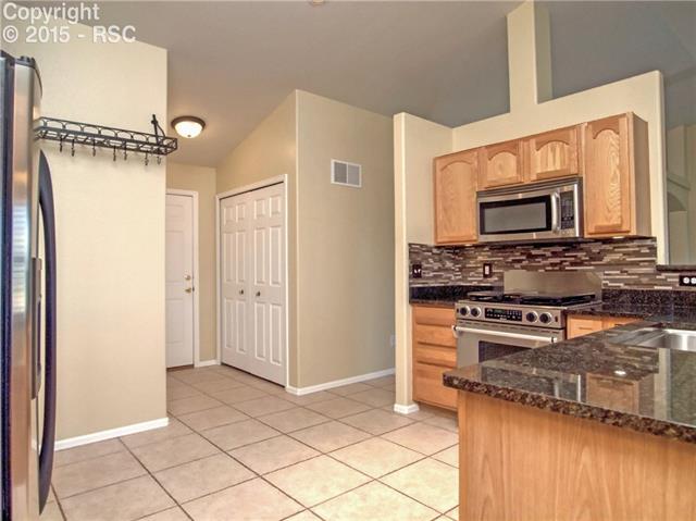 8756 Del Rio Road Peyton, CO 80831 - Photo 12 of 31 Kitchen has ceramic tile floors, granite counters and beautiful back splash