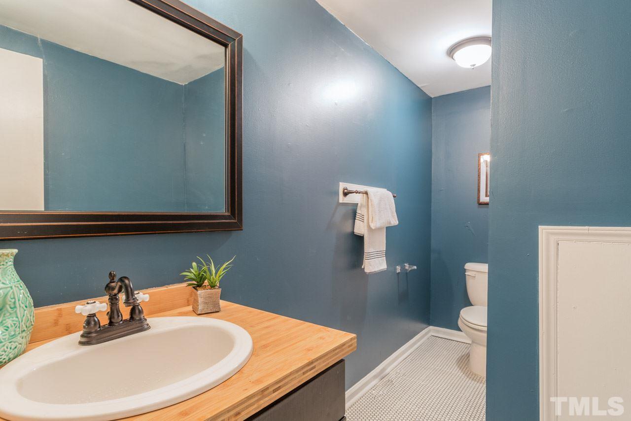 1215 Kent Road Raleigh, NC 27606 - Photo 9 of 11 a bathroom with a sink and a mirror