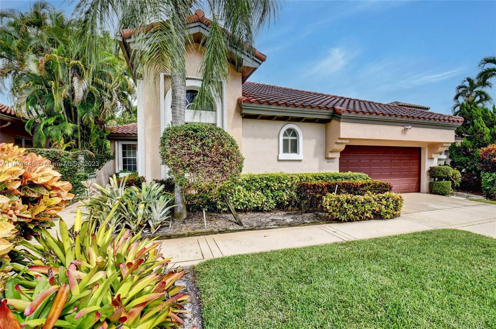 6325 Northwest 23rd Road Boca Raton, FL 33434 - Photo 13 of 84 a front view of a house with a garden