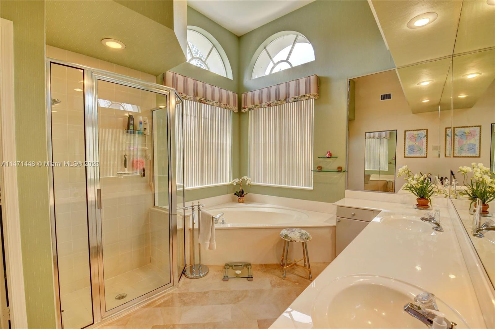 6325 Northwest 23rd Road Boca Raton, FL 33434 - Photo 45 of 84 a spacious bathroom with a tub shower and mirror