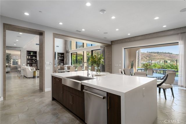a dining room with furniture and a potted plant