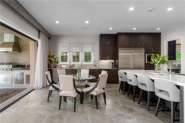 a kitchen with kitchen island granite countertop a sink stainless steel appliances and cabinets