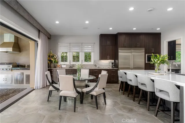 a kitchen with kitchen island granite countertop a sink stainless steel appliances and cabinets