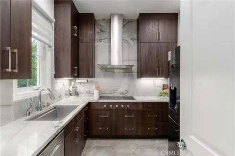 a bedroom with a large bed and a flat tv screen on dresser