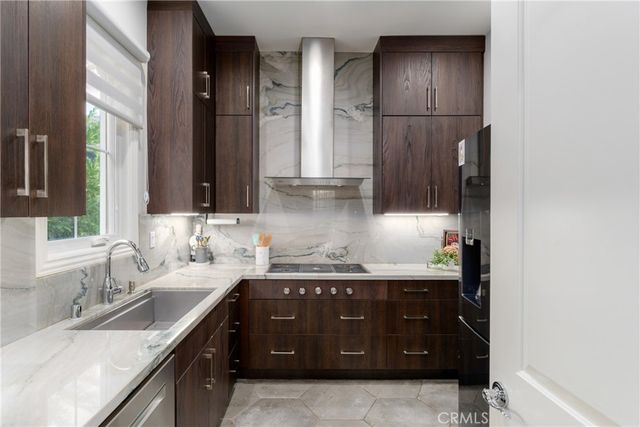 a bedroom with a large bed and a flat tv screen on dresser