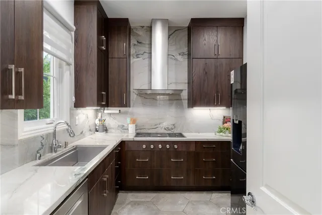 a bedroom with a large bed and a flat tv screen on dresser
