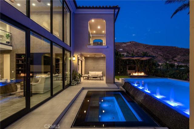 a swimming pool with yard in front of it