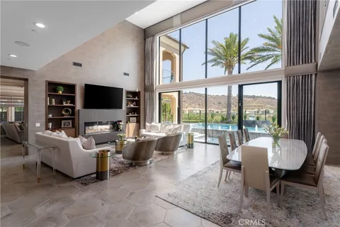 a dining room with furniture a window and a flat screen tv