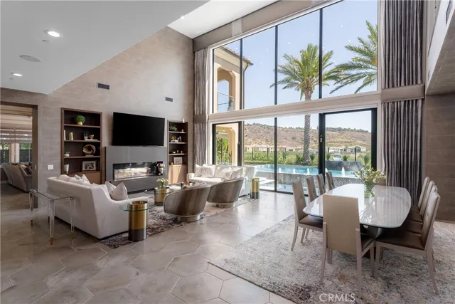 a dining room with furniture a window and a flat screen tv