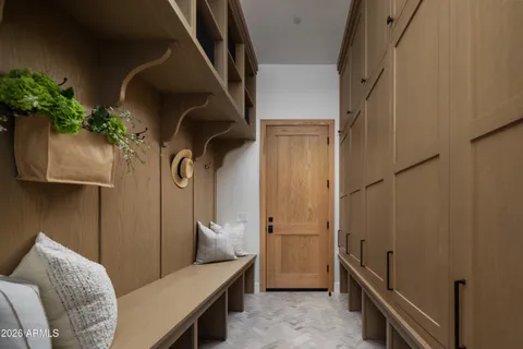 a bedroom with a bed and a potted plant on the wall