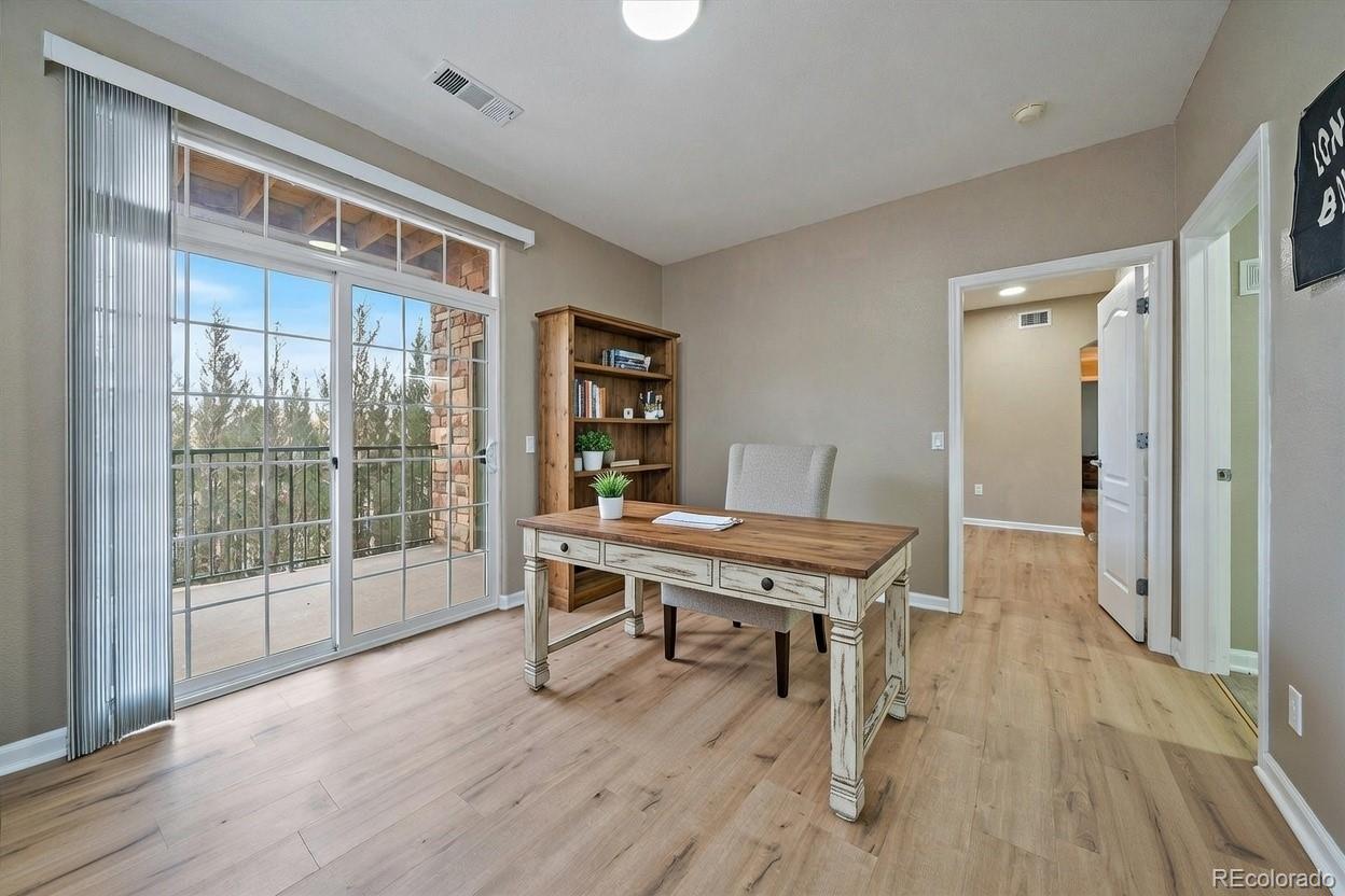 18611 Stroh Road, Unit 5102 Parker, CO 80134 - Photo 11 of 19 a view of a workspace with furniture and wooden floor