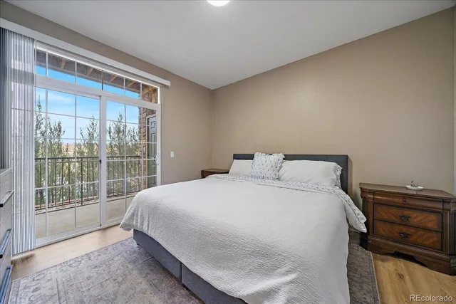 a large bed sitting in a bedroom next to a window