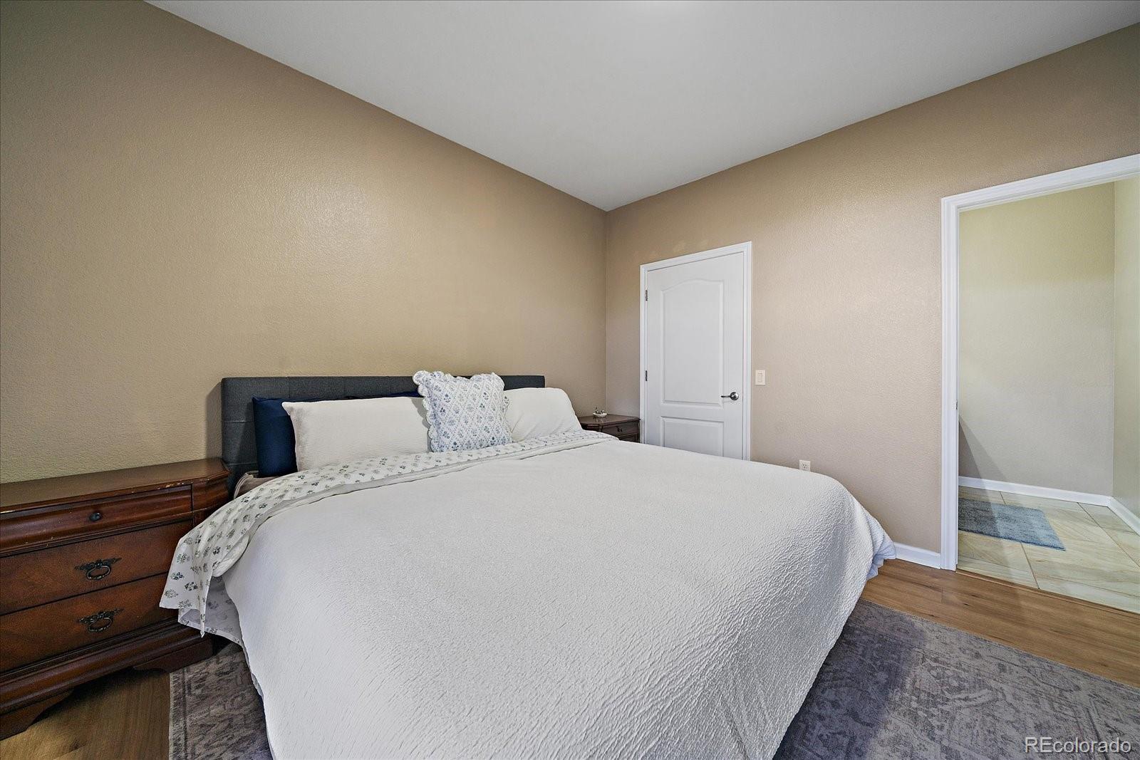 18611 Stroh Road, Unit 5102 Parker, CO 80134 - Photo 13 of 21 a large bed sitting in a bedroom next to a window
