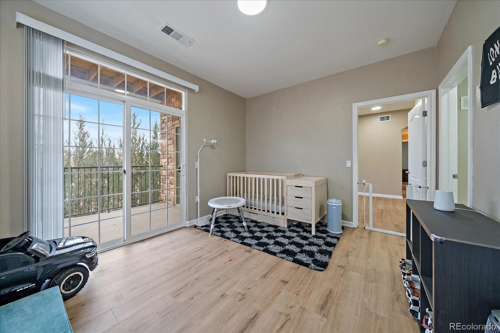 18611 Stroh Road, Unit 5102 Parker, CO 80134 - Photo 17 of 21 a bedroom with furniture and a window
