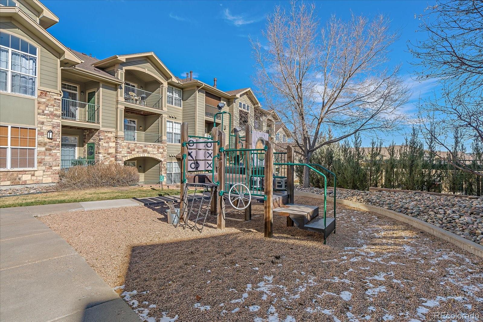 18611 Stroh Road, Unit 5102 Parker, CO 80134 - Photo 18 of 19 a backyard of a house with table and chairs