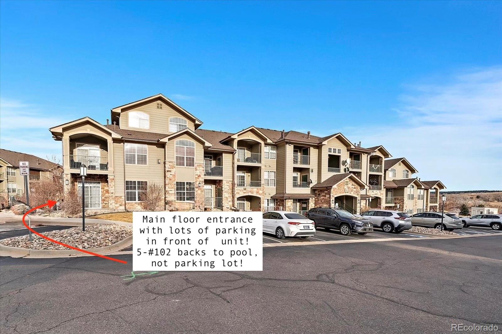 18611 Stroh Road, Unit 5102 Parker, CO 80134 - Photo 19 of 19 a view of a white building among the street and parked cars