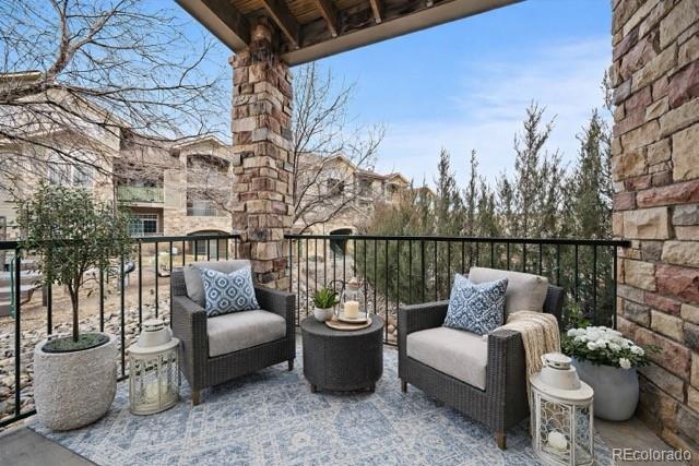 18611 Stroh Road, Unit 5102 Parker, CO 80134 - Photo 2 of 19 a balcony with couch and potted plants