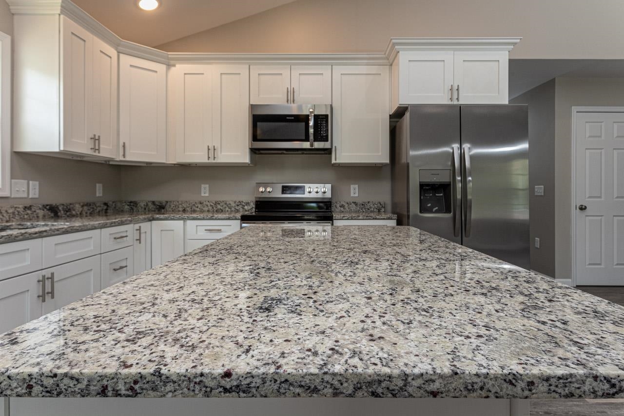 17030 Mt Pleasant Road Elkton, VA 22827 - Photo 8 of 22 a kitchen with stainless steel appliances kitchen island granite countertop a stove refrigerator and cabinets
