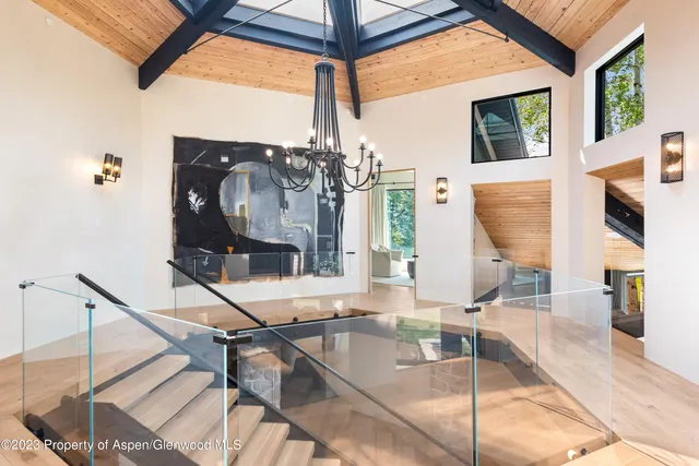 a spacious bedroom with a bed and a fireplace with a flat tv screen