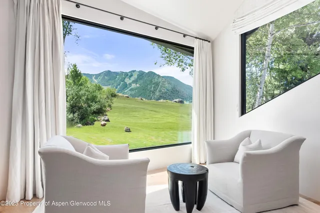 a bathroom with a double vanity sink a mirror and a bathtub