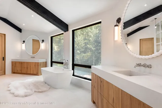 a large spacious bathroom with a large tub and shower