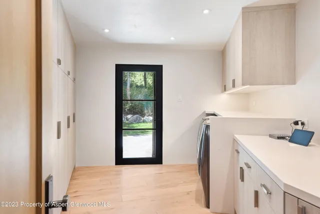 a view of entryway and hall with wooden floor