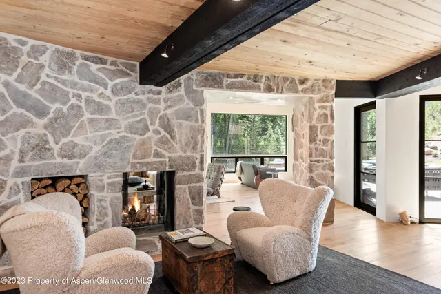 a living room with furniture and floor to ceiling windows