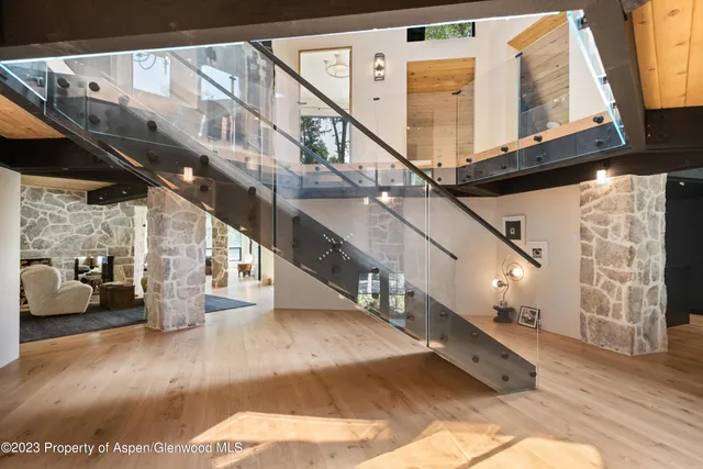 a view of entryway and hall with wooden floor