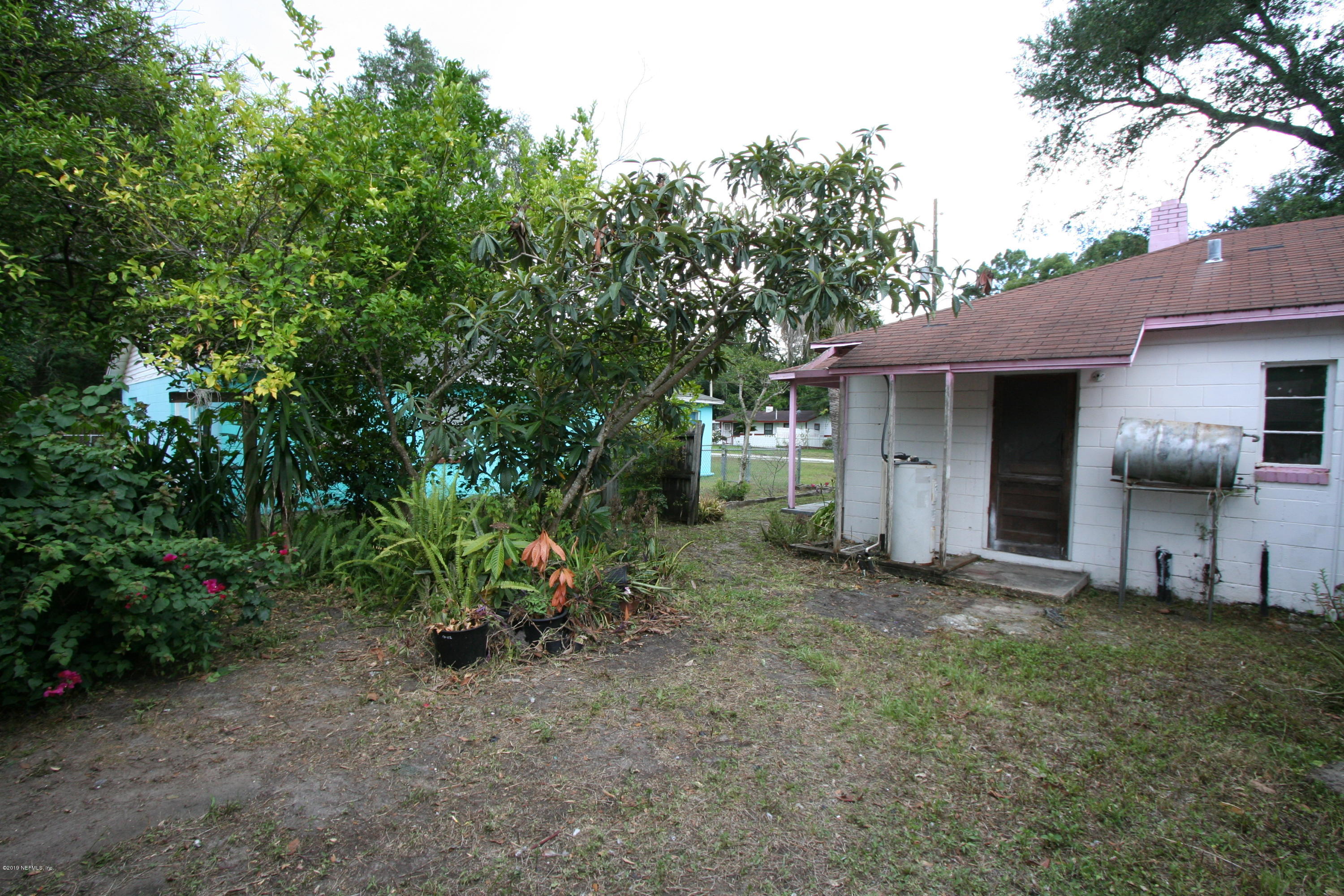 3831 Freeman Road Jacksonville, FL 32207 - Photo 9 of 11 a view of a chair and table in backyard of the house
