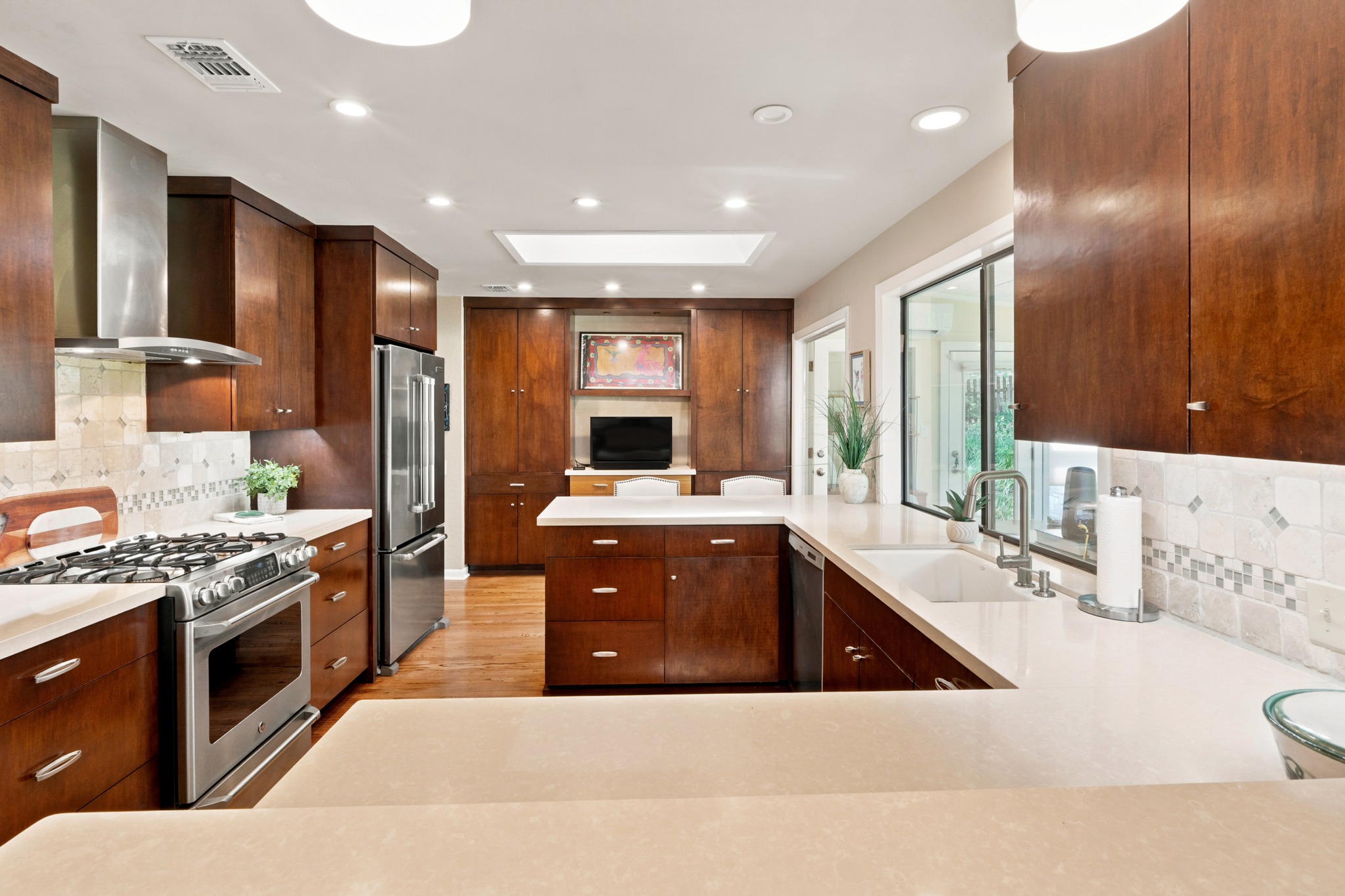 1904 Stoneridge Road Austin, TX 78746 - Photo 12 of 40 Renovated kitchen features custom cabinetry, quartz countertops and abundant workspace.