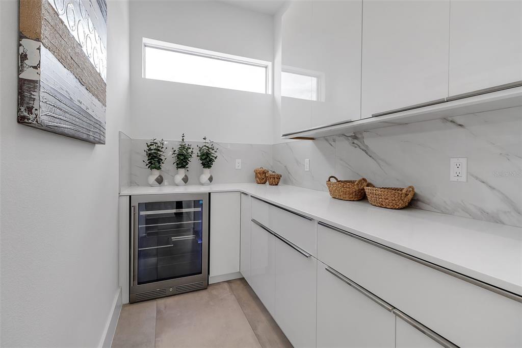 2532 Fruit Tree Drive Sarasota, FL 34239 - Photo 14 of 38 a kitchen with a refrigerator and cabinets