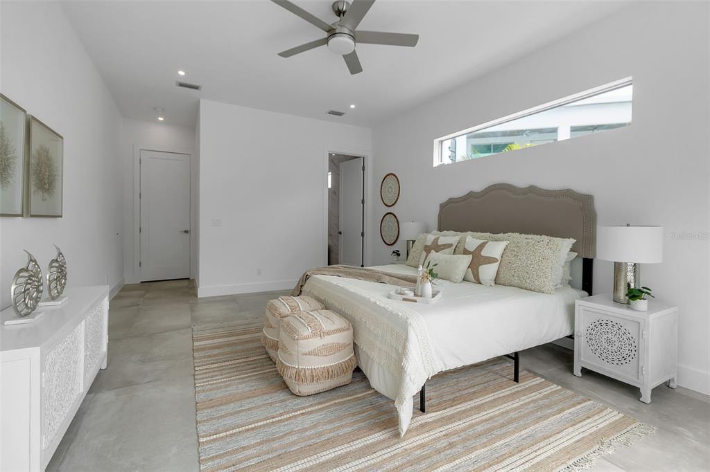 2532 Fruit Tree Drive Sarasota, FL 34239 - Photo 19 of 38 a spacious bedroom with a bed and ceiling fan