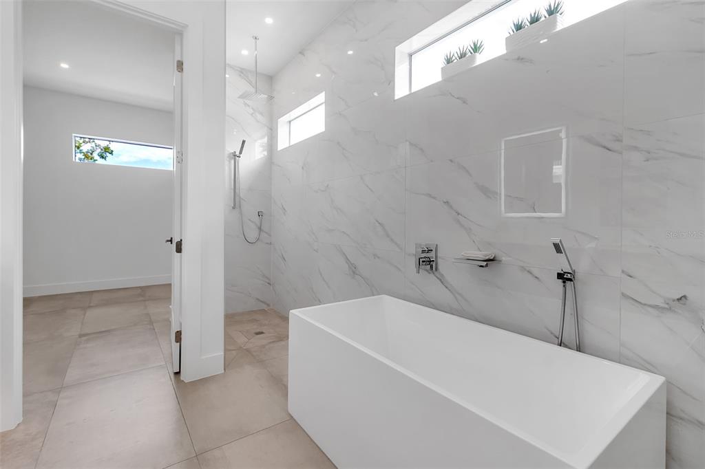 2532 Fruit Tree Drive Sarasota, FL 34239 - Photo 22 of 38 a bathroom with a bathtub and a shower