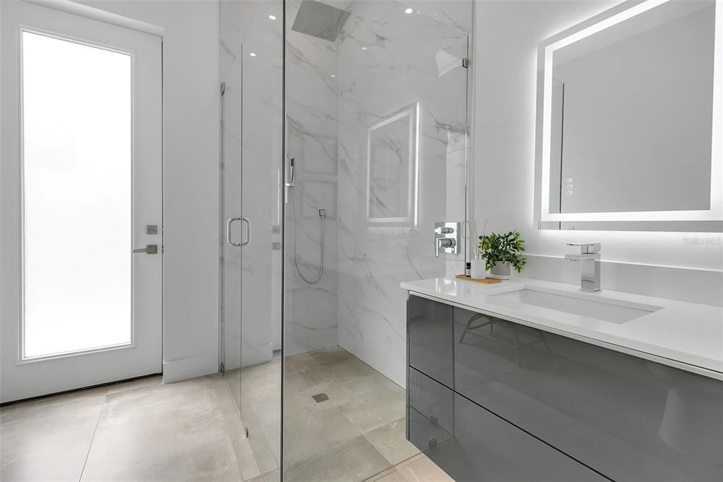 2532 Fruit Tree Drive Sarasota, FL 34239 - Photo 26 of 38 a bathroom with a shower sink and mirror
