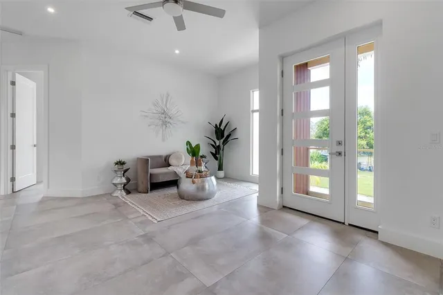 a living room with furniture and a potted plant
