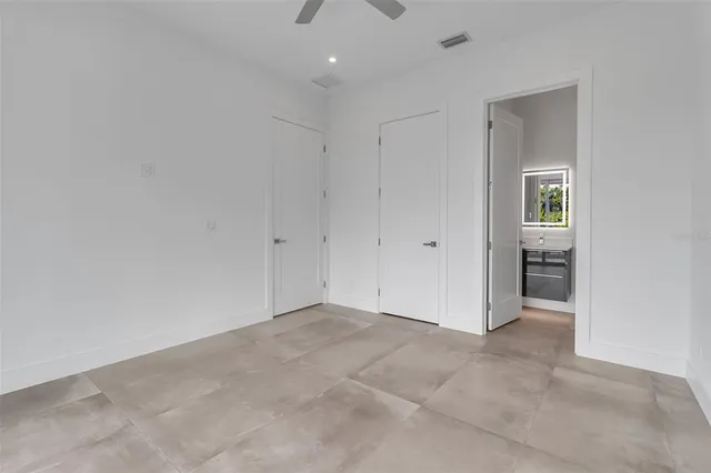 a bathroom with a toilet sink vanity and shower