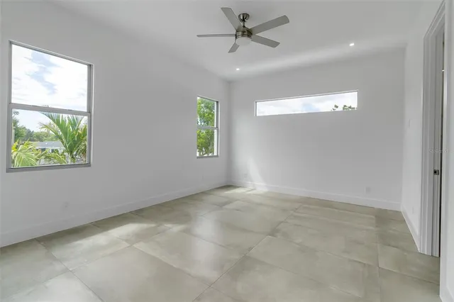 a view of an empty room and a ceiling fan