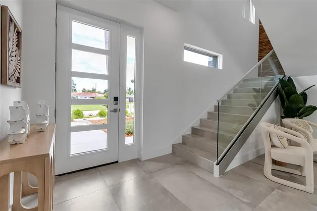 a view of an entryway with wooden floor and windows