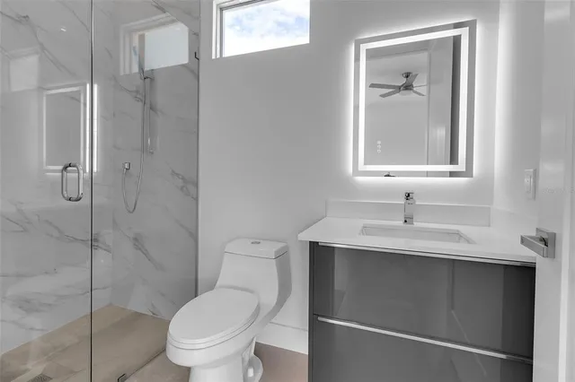 a view of a swimming pool with two potted plants in front of door