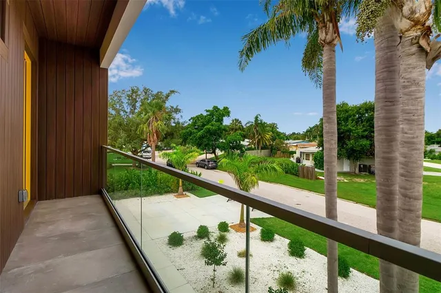a balcony with furniture and a potted plant