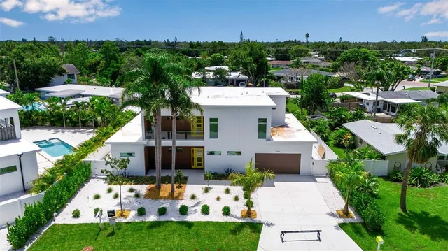 an aerial view of residential house with outdoor space and swimming pool