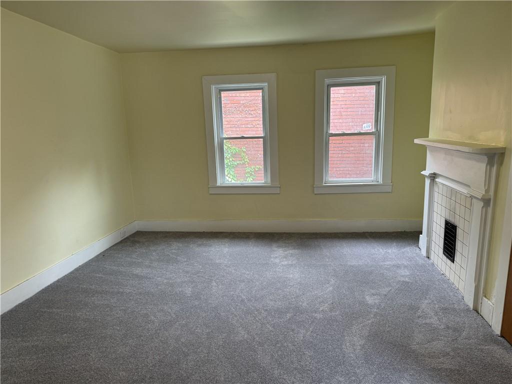 522 Cubbage Street Carnegie, PA 15106 - Photo 11 of 22 an empty room with windows and fireplace