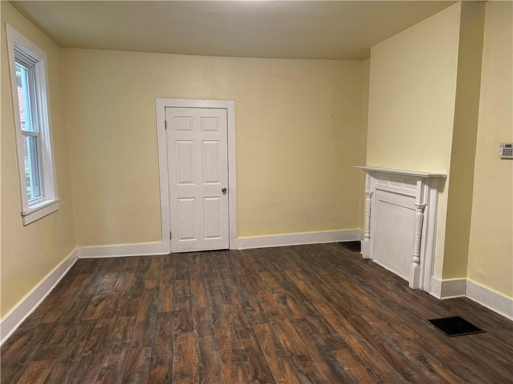 522 Cubbage Street Carnegie, PA 15106 - Photo 17 of 22 a view of an empty room with wooden floor and a window