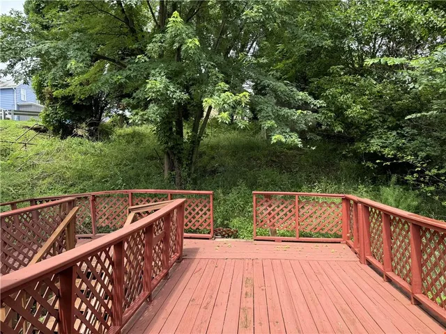 a view of balcony with wooden floor and fence