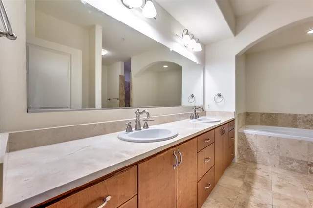 a bathroom with a sink double vanity granite and a mirror