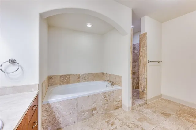 a bathroom with a bathtub and a shower