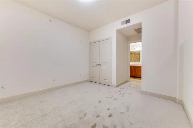 an empty room with closet area