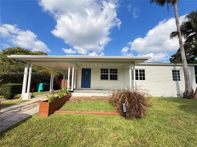 a kitchen with stainless steel appliances granite countertop a refrigerator a stove and a sink